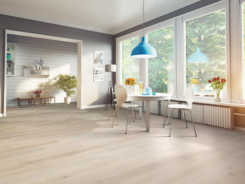 Modern living room with light hardwood flooring.